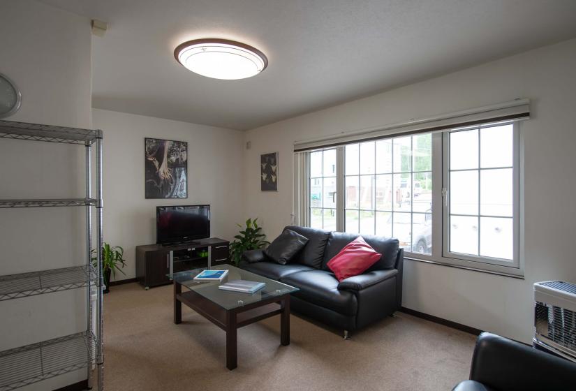 Black sofa under window with coffee table