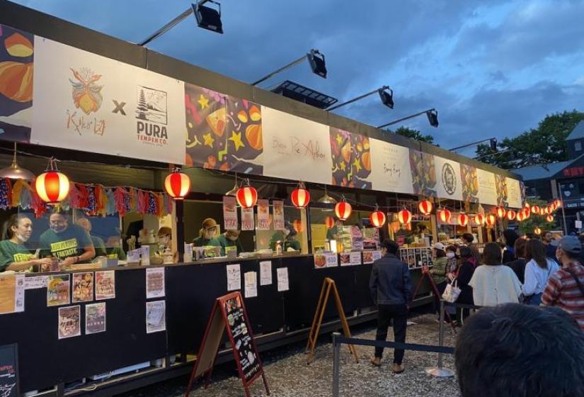 A line of colourful food stalls at the festival