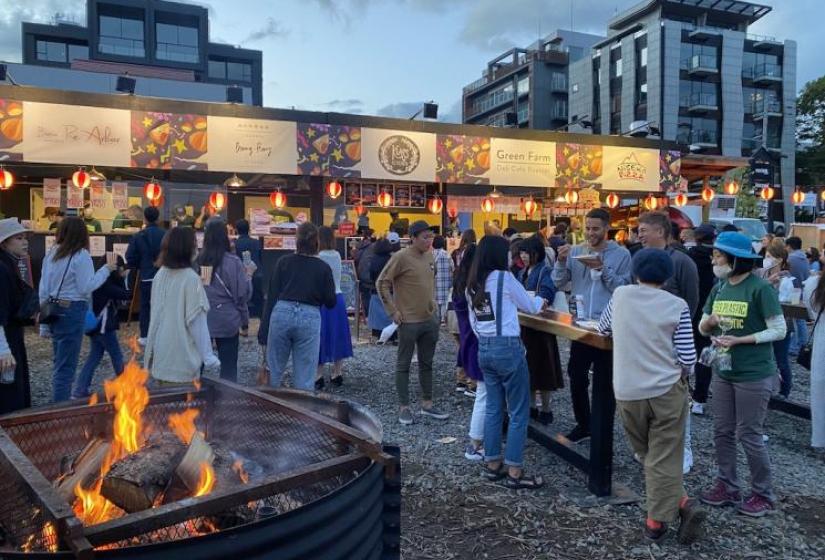 Good times had by all A fire pit and crowd in front of the food stalls.
