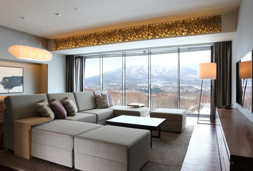 brown sofas with floor to ceiling windows