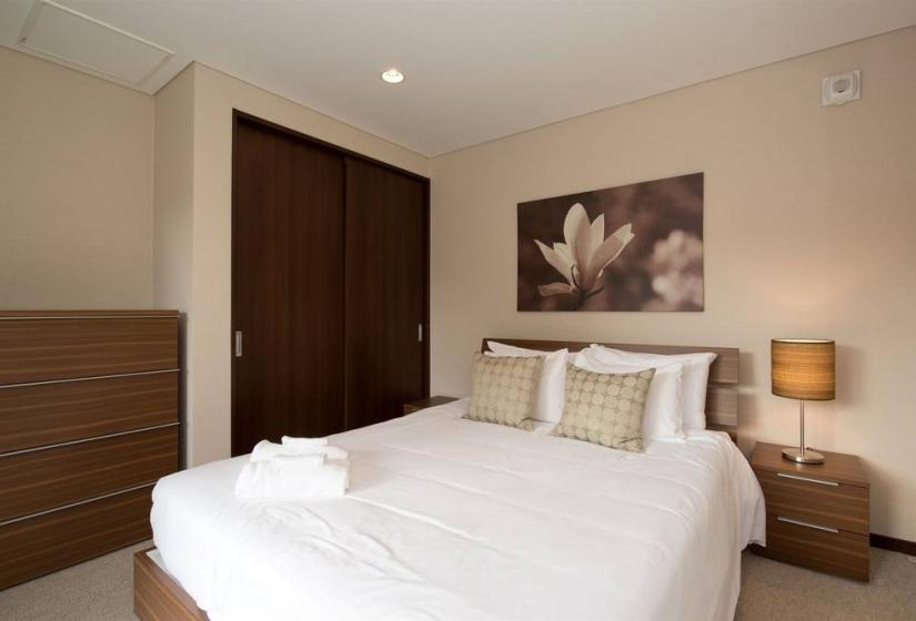 double bed with towels closet and flower painting