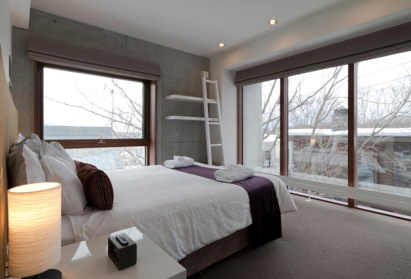 bedroom with double bed and large window space