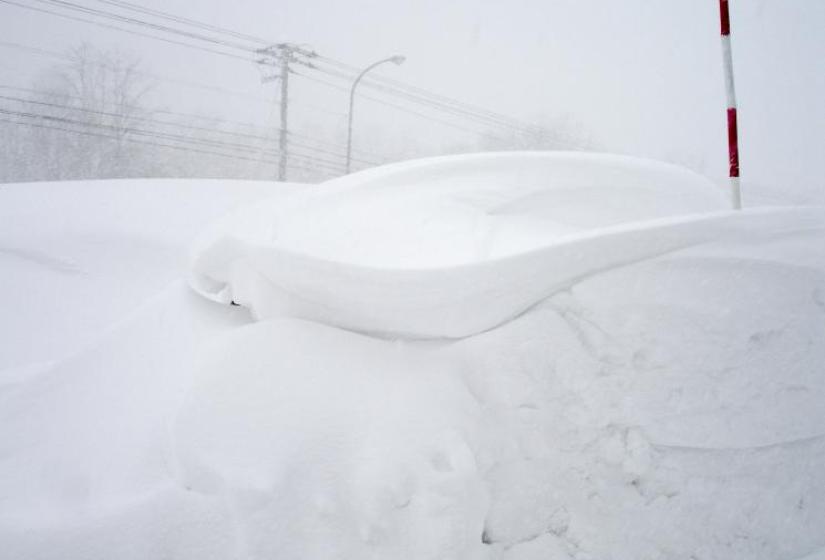 Hiromi's car is under that snow- marked with a pole Hiromi's car is under that snow- marked with a pole