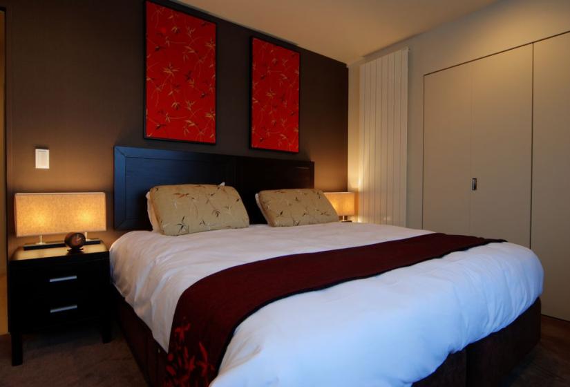 king bed with radiator and red wall banners