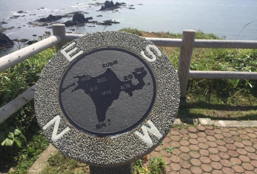A concrete compass at Erimo Concrete compass with rocky island in back ground
