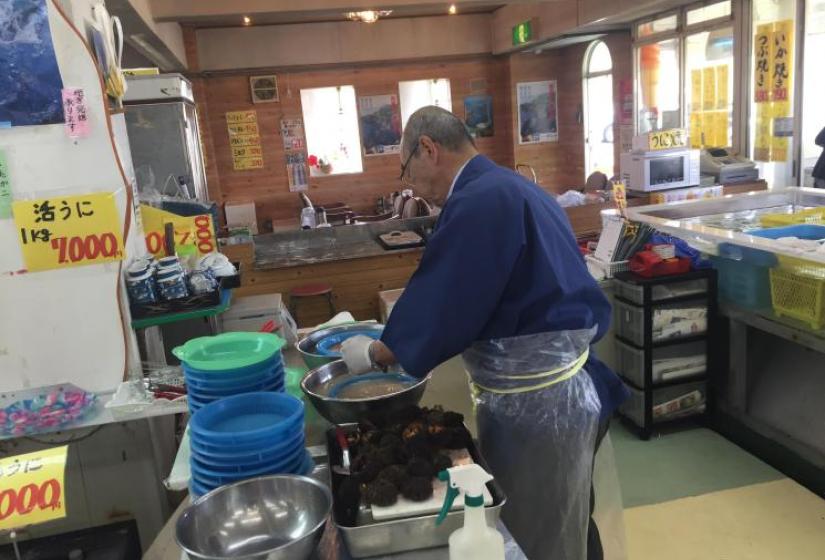 A man prepares sea urchin