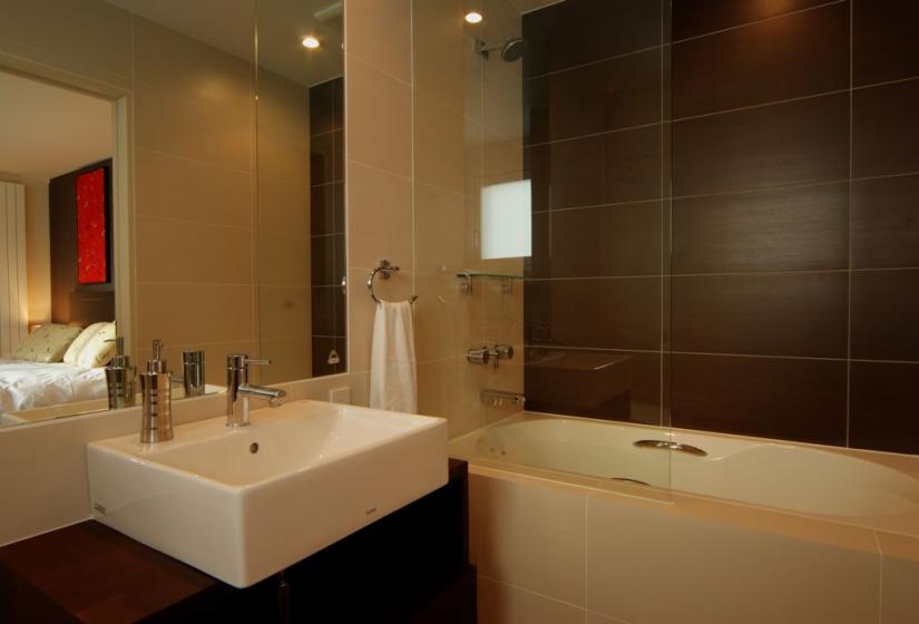 bathroom with large mirror, bath shower