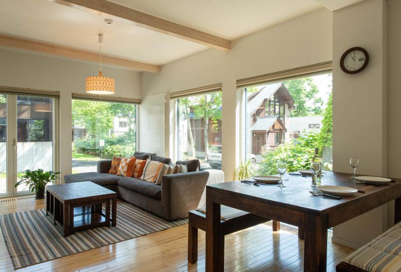 Wooden dining table with sofa in background