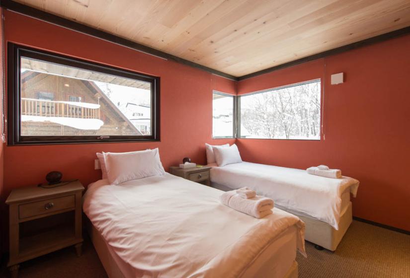 twin beds red bedroom with windows