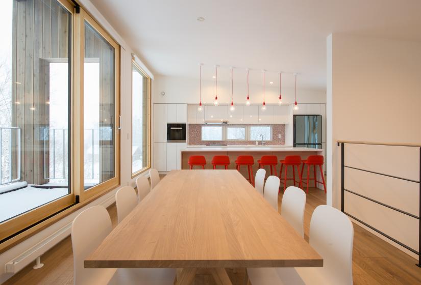 main dining table with chairs and bar in background