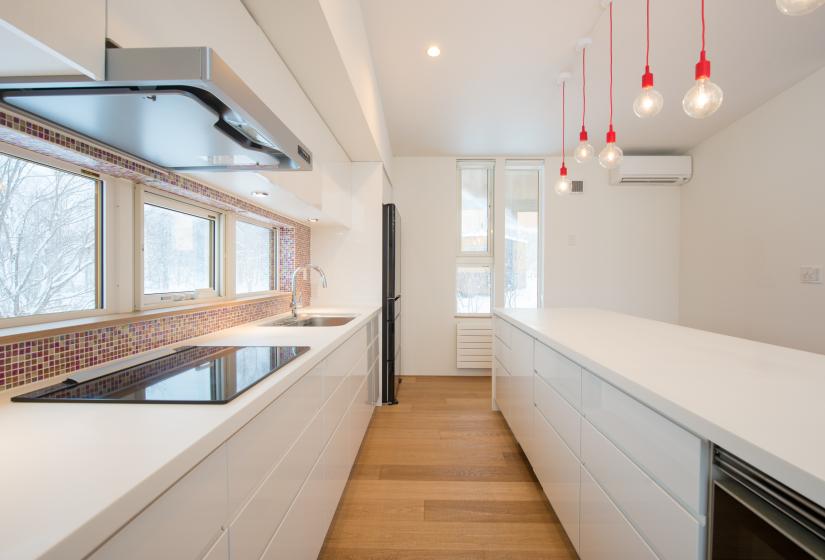 kitchen counter with stove, sink, and bar