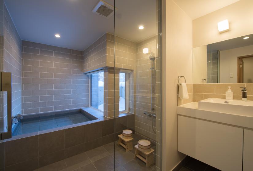 bathtub, standing shower with glass door and sink with mirror