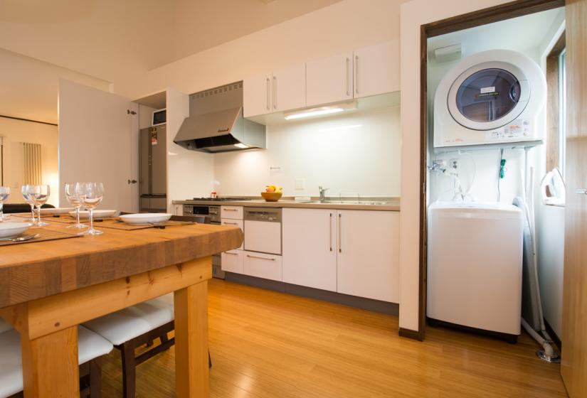 Kitchen area with washer and dryer off to the side