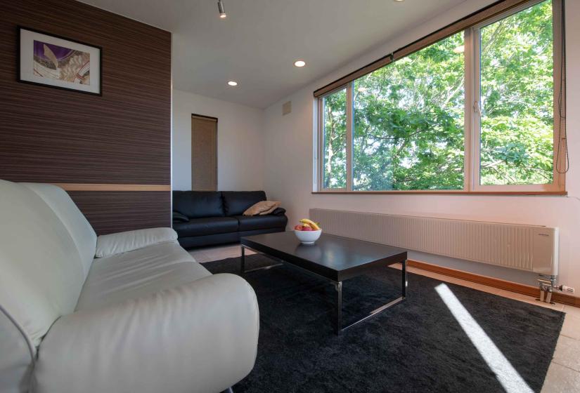 White sofa and black coffee table with fruit