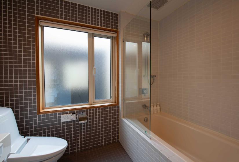 bathroom with brown tiled wall