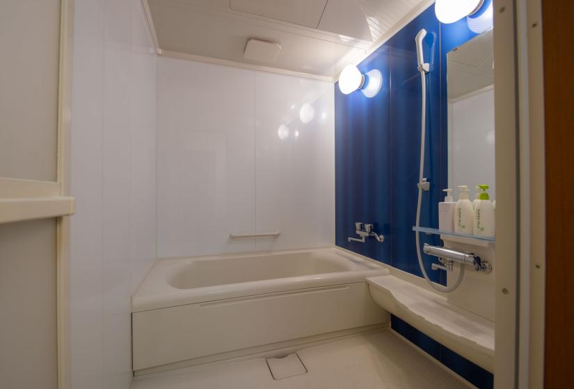 White bath with blue splash panel