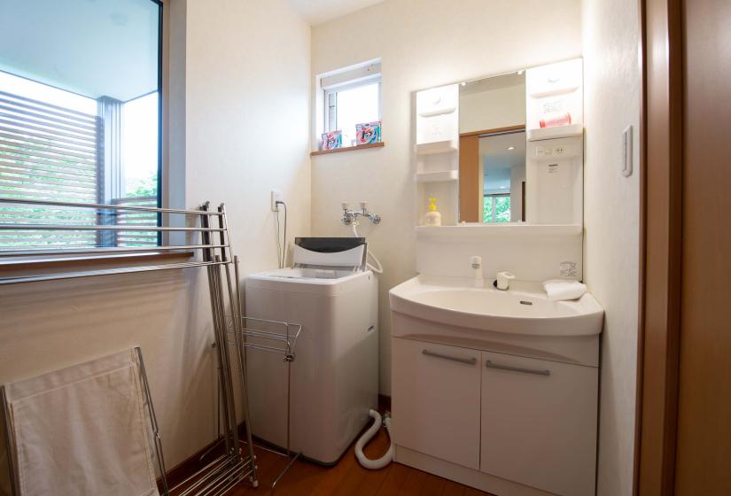 white vanity with washing machine beside it