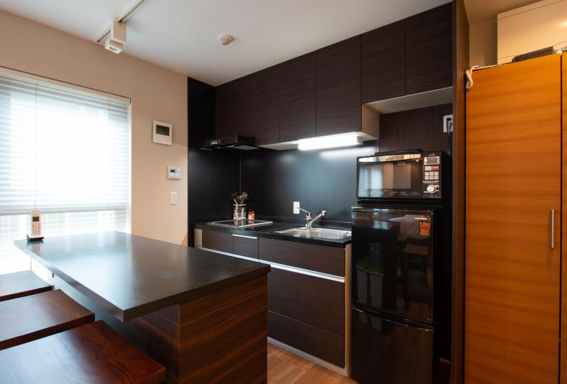 Breakfast bar and black refrigerator