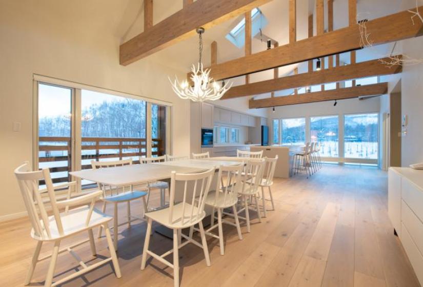 A white dining table with deer horn chandelier