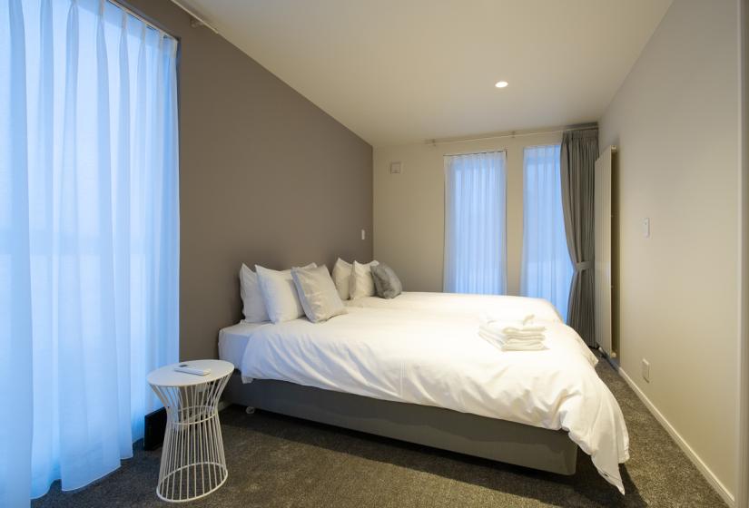 bedroom with grey carpet and white bed