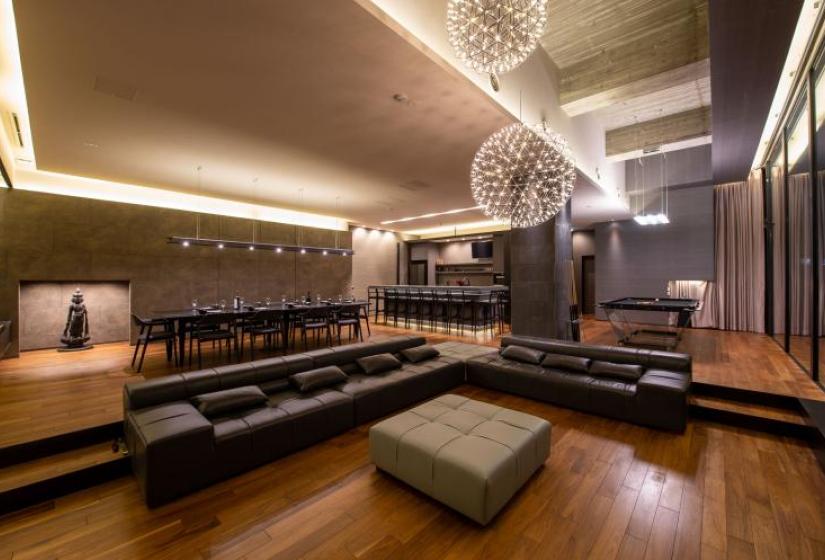 Comfort and style A lounge suite with dining table and kitchen behind