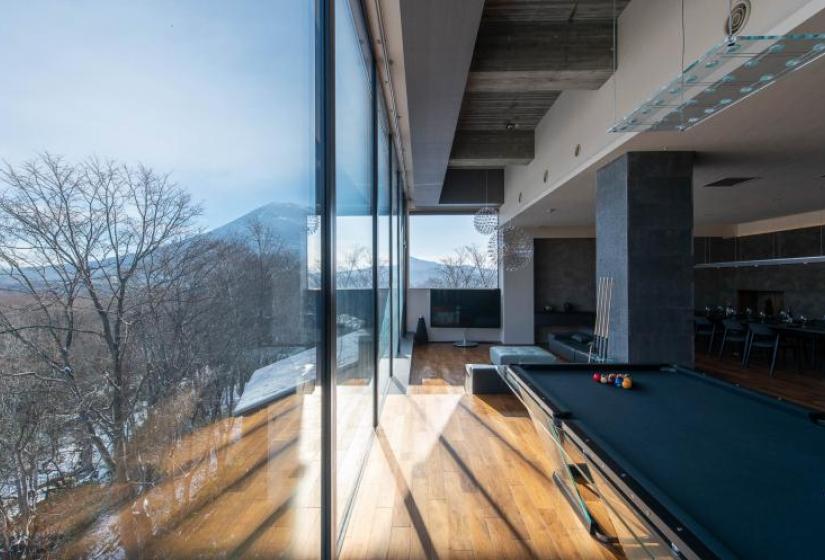 A view of Mount Yotei through large floor to ceiling windows
