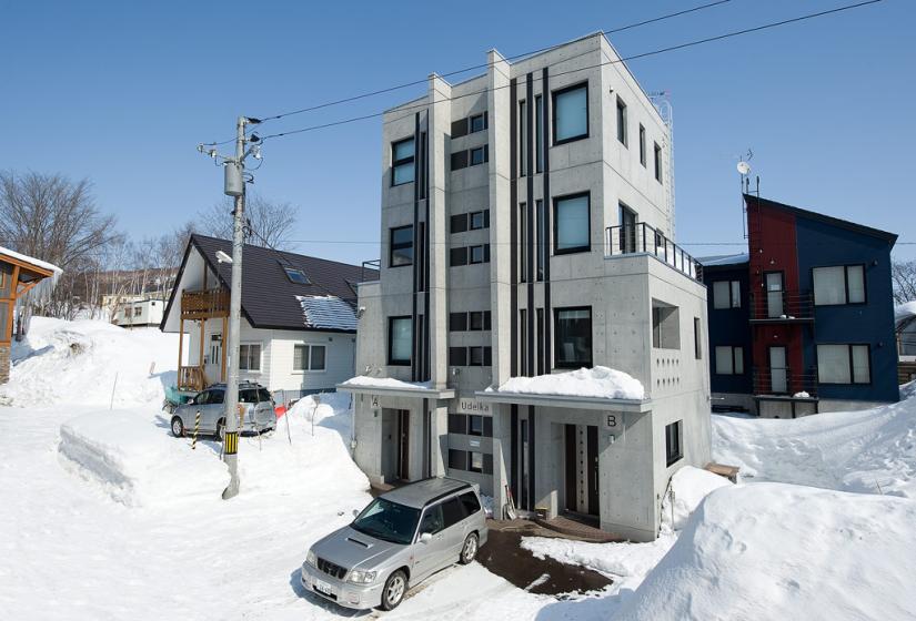 Udelka exterior building view with parking in winter