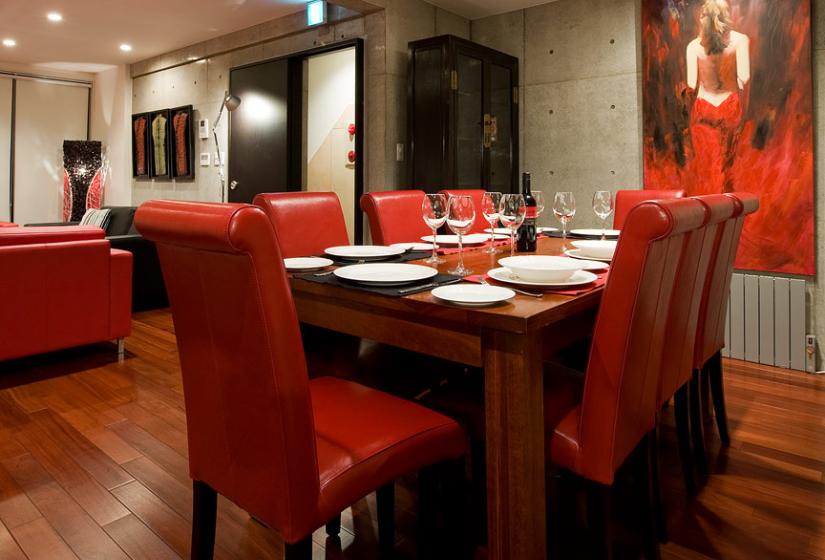 Dining table with red seats and wine glasses