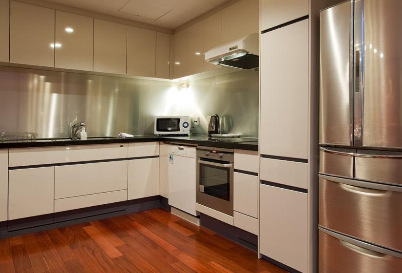 Silver fridge, bench top and microwave