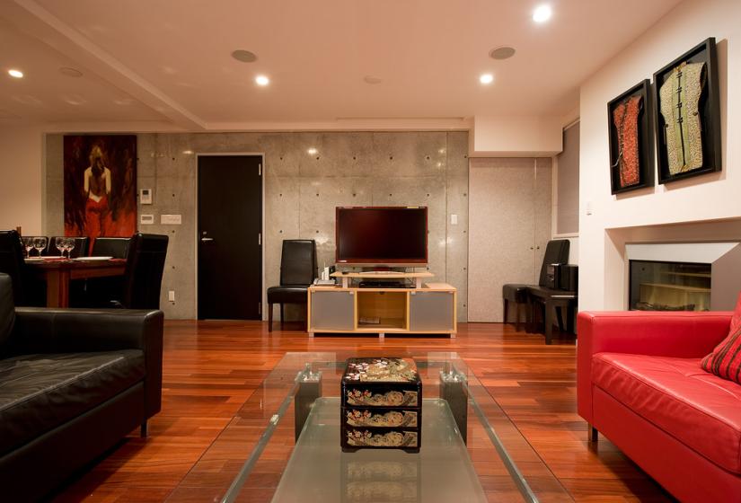 living area with glass coffee table, television and large leather couches