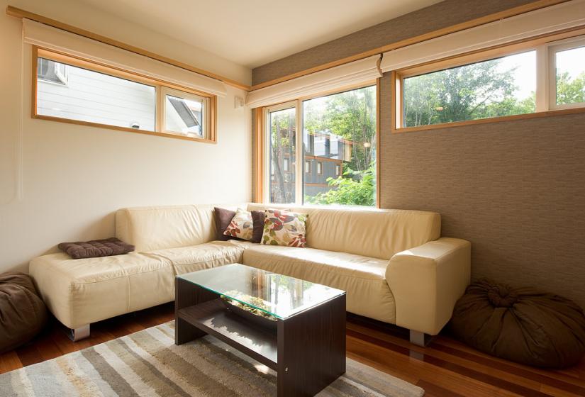 Light tan sofas with coffee table on striped mat