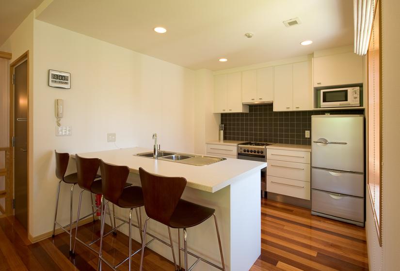 white counter top with stools at breakfast bar