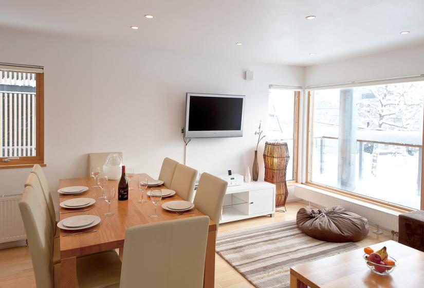 Living room with striped mat and dining table