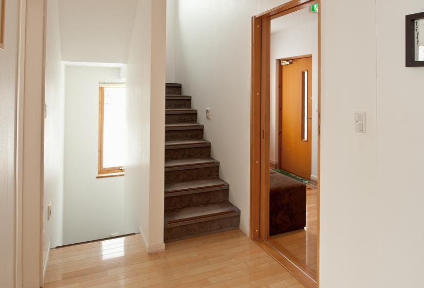 Hallway with brown stairs