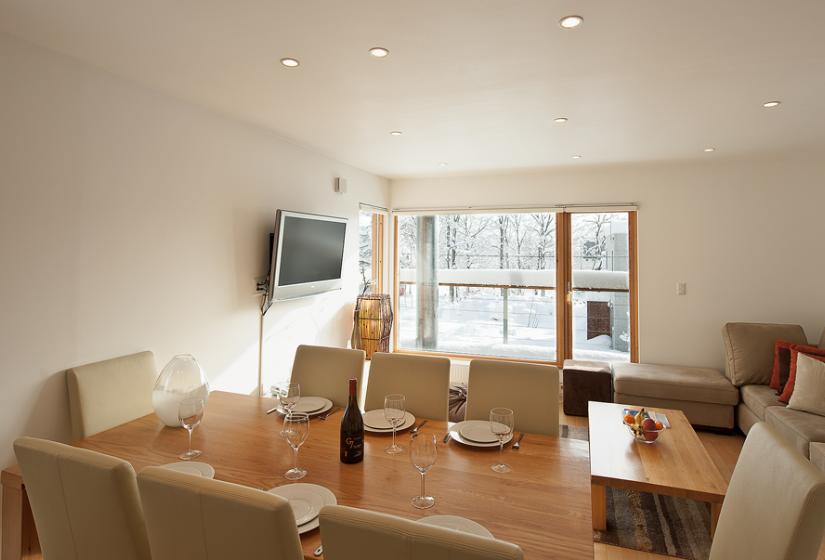 Dining table set with white plates