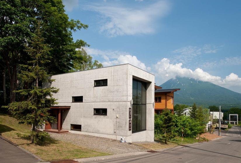 exterior of building with road, forrest, and mountain