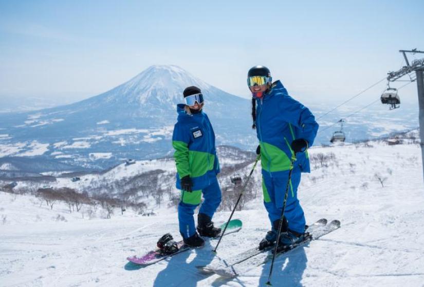 A different winter for ski instructors Two Go Snow ski instructors with Mount Yotei in the back ground