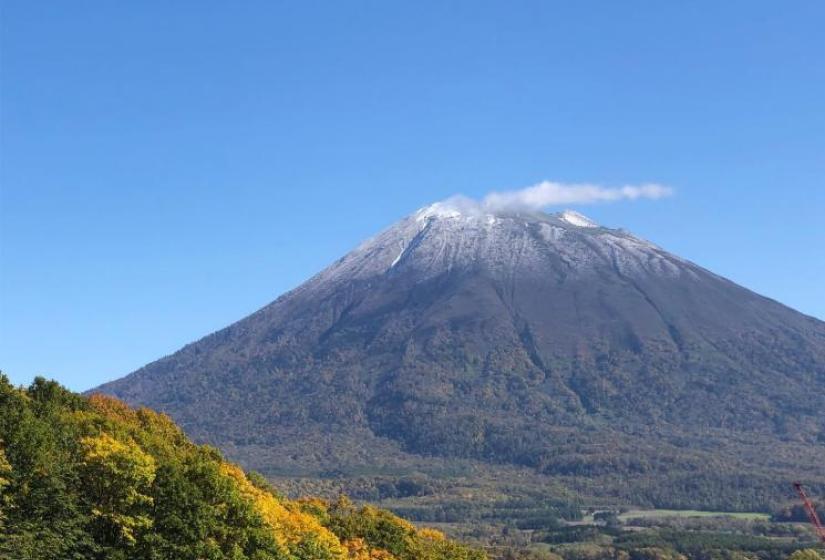 Mt Yotei with snow on peak and fall colours in the foreground