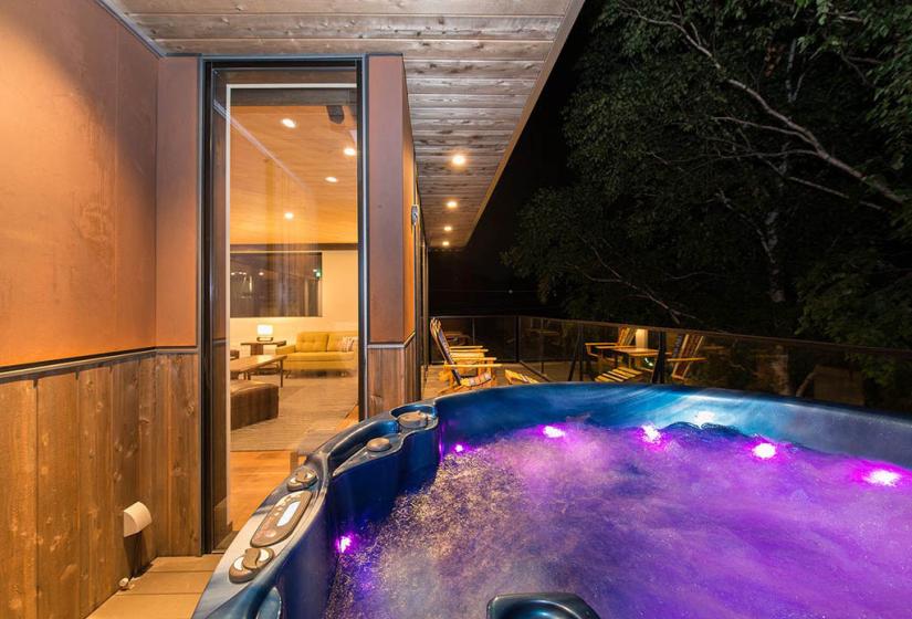 Jacuzzi on deck at night with party lights