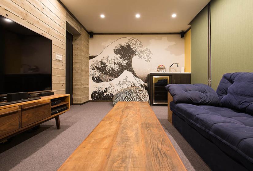 couch, coffee, table, TV with Hokusai Tsunami wall art