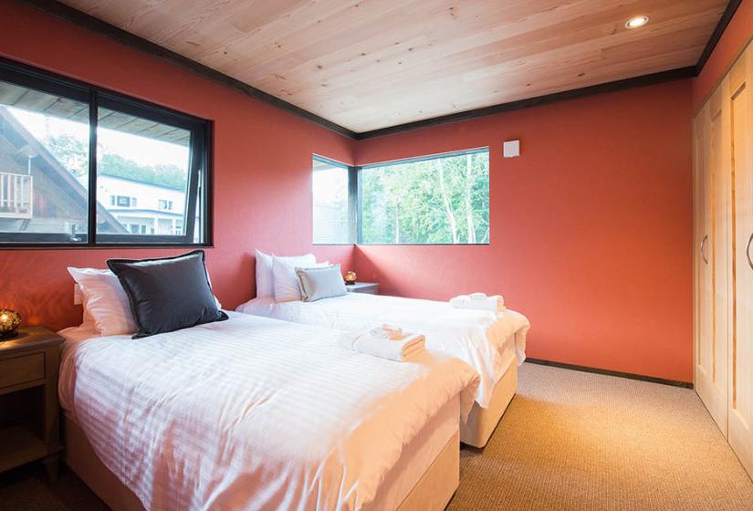 red room with twin beds and windows