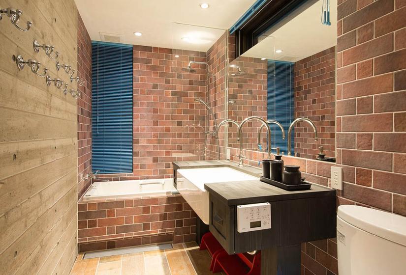 shower with bathtub sink and mirror brick tile walls