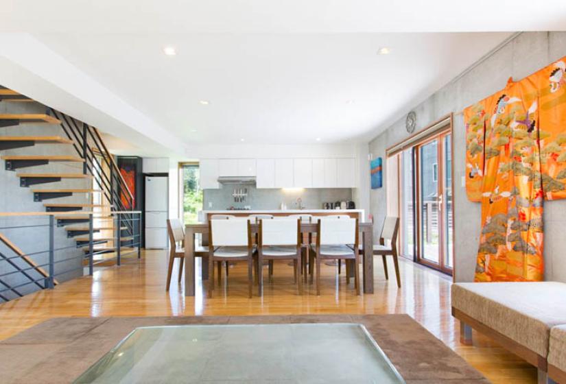 dining table with white chairs and stairs