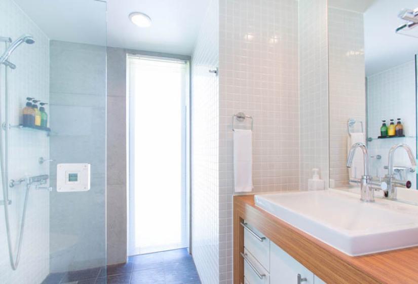 bathroom window with sink and wood trim