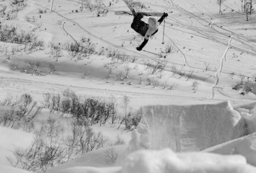 A skiier flies high on a jump