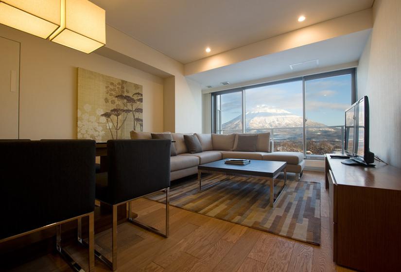 living area with hardwood floors couches wintertime yotei view