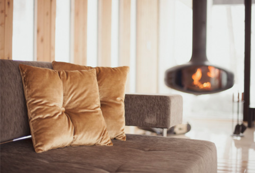 sofa and pillows with fire place in the background