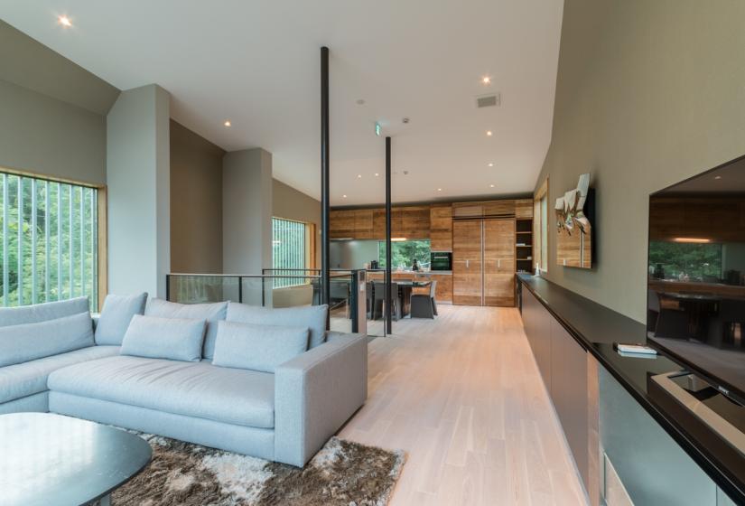 main living area with rug and hallway to dining room