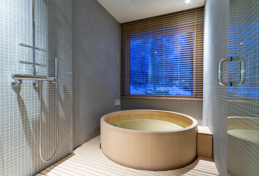 A shower and round wooden hinoki bath