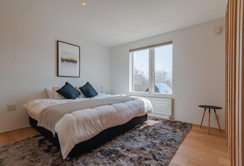 master bedroom with king size bed and wall mounted photograph